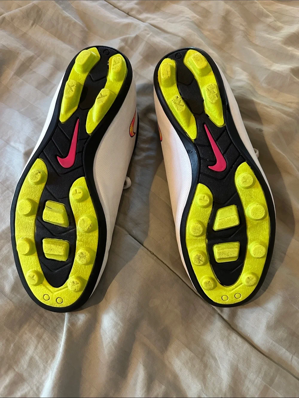 Nike Kids White Soccer Cleats with Neon Yellow and Pink Swoosh